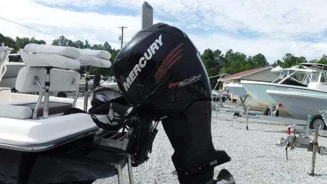 Slide: The Image of 2013 ShearWater 25 Bay boat with Mercury outboard motor in a marina setting. - 12