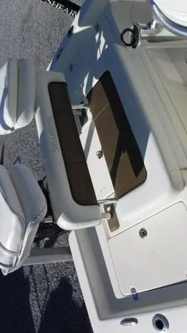 Slide: The Image of 2013 ShearWater 25 Bay boat interior with seating and storage compartments. - 14