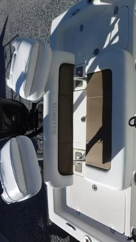 Slide: The Image of 2013 ShearWater 25 Bay boat interior with seating and storage compartments. - 15