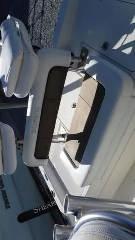 Slide: The Image of 2013 ShearWater 25 Bay boat interior with seating and storage. - 16