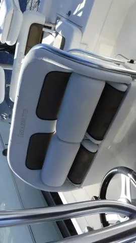 Slide: The Image of 2013 ShearWater 25 Bay boat interior with cushioned seating and steering wheel. - 17