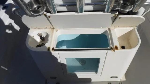 Slide: The Image of 2013 ShearWater 25 Bay boat livewell and storage compartments. - 21