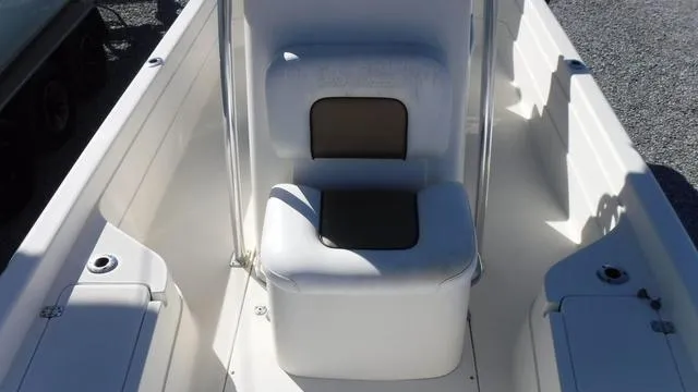 Slide: The Image of 2013 ShearWater 25 Bay boat interior with white seating and storage compartments. - 22