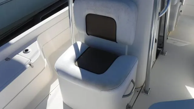 Slide: The Image of 2013 ShearWater 25 Bay boat seat with white and black cushioned design. - 23