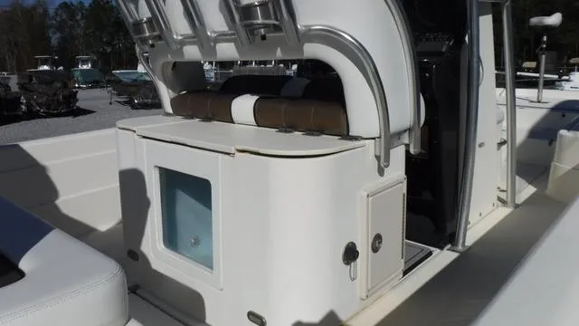 Slide: The Image of 2013 ShearWater 25 Bay boat interior with seating and storage compartments. - 26