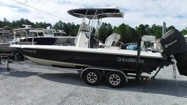 Slide: The Image of 2013 ShearWater 25 Bay boat on trailer, parked outdoors. - 5