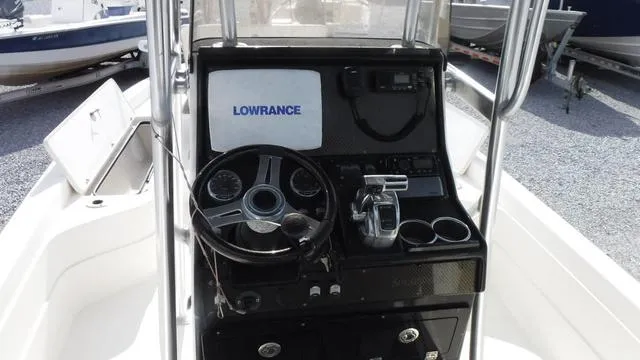 Slide: The Image of 2013 ShearWater 25 Bay boat console with steering wheel and Lowrance system. - 6