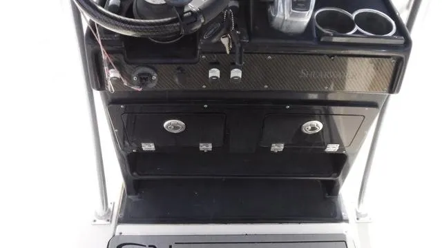 Slide: The Image of Control panel of a 2013 ShearWater 25 Bay boat with storage compartments. - 8