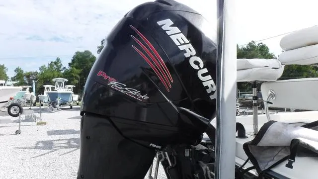 Slide: The Image of Mercury Pro XS outboard motor on 2013 ShearWater 25 Bay boat, parked in a marina. - 9