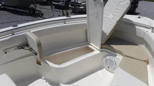 Slide: The Image of 2025 Bulls Bay 255 CC boat interior with open storage compartment and seating. - 11