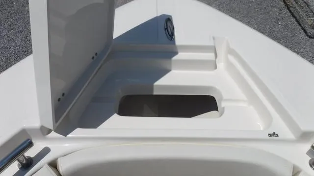 Slide: The Image of 2025 Bulls Bay 255 CC boat storage compartment with open lid. - 13