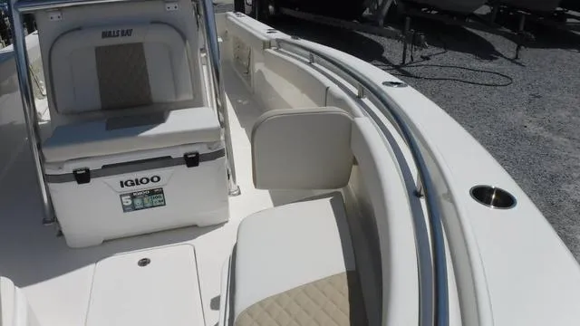 Slide: The Image of 2025 Bulls Bay 255 CC boat interior with seating and Igloo cooler. - 14