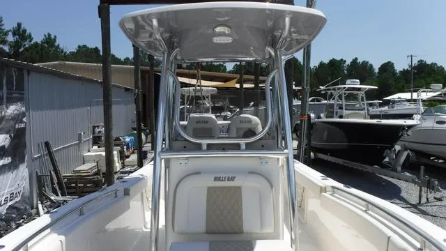 Slide: The Image of 2025 Bulls Bay 255 CC boat with T-top, docked in a marina. - 16