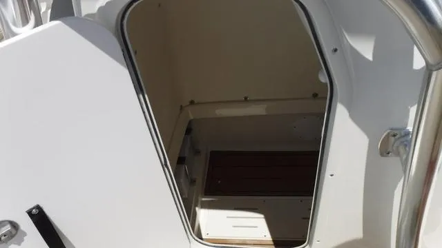 Slide: The Image of 2025 Bulls Bay 255 CC boat cabin interior with open door. - 18