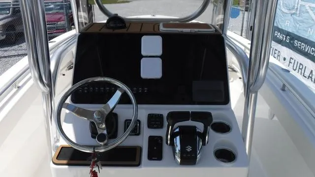 Slide: The Image of 2025 Bulls Bay 255 CC boat console with steering wheel and controls. - 19