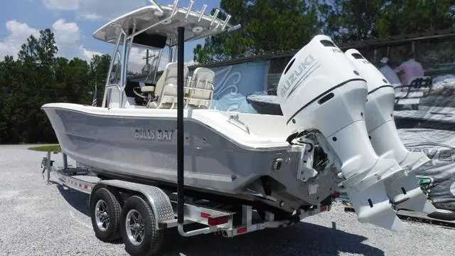 Slide: The Image of 2025 Bulls Bay 255 CC boat on trailer with dual Suzuki engines. - 2