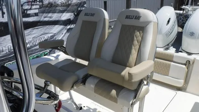 Slide: The Image of 2025 Bulls Bay 255 CC boat seats with beige and white upholstery. - 21
