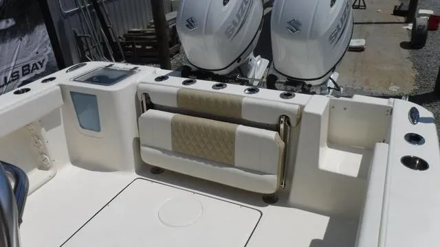Slide: The Image of 2025 Bulls Bay 255 CC boat interior with dual Suzuki engines and foldable seating. - 24