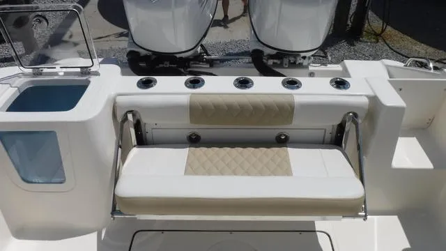 Slide: The Image of 2025 Bulls Bay 255 CC boat interior with cushioned seating and rod holders. - 26