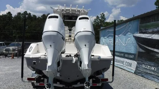 Slide: The Image of 2025 Bulls Bay 255 CC boat with dual outboard engines on trailer. - 6