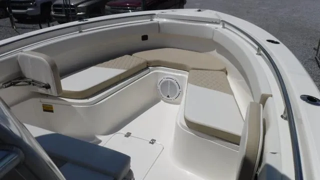 Slide: The Image of 2025 Bulls Bay 255 CC boat interior with cushioned seating and speaker. - 9