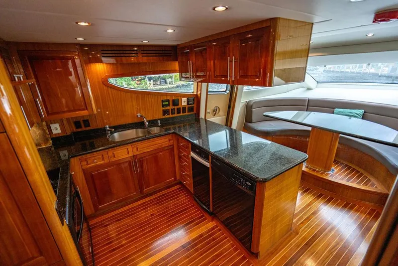 Slide: The Image of Luxurious 2007 Hatteras Enclosed Flybridge yacht interior with sleek kitchen and dining area. - 10