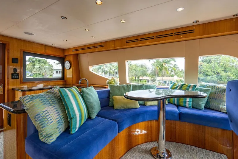 Slide: The Image of Luxurious 2007 Hatteras Enclosed Flybridge interior with plush seating and scenic windows. - 14