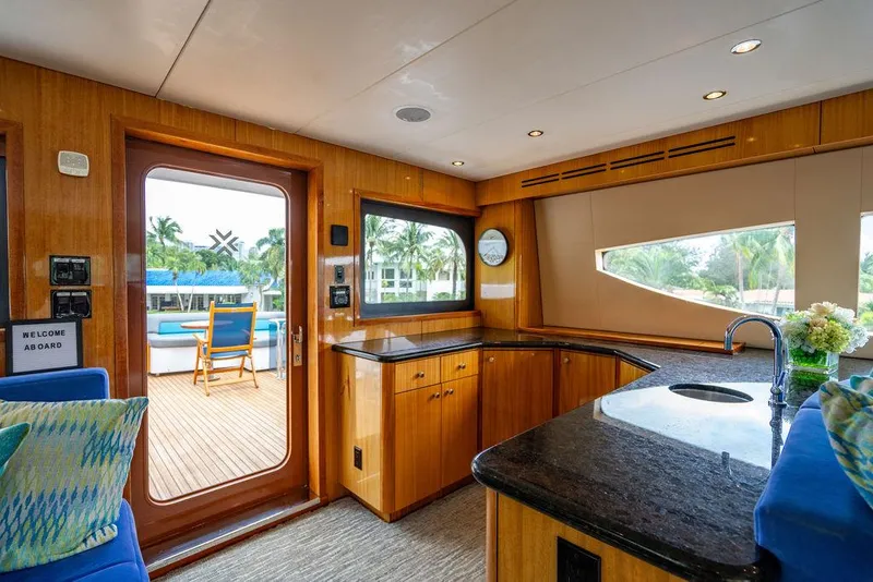 Slide: The Image of Luxurious interior of 2007 Hatteras Enclosed Flybridge yacht with modern kitchen and outdoor view. - 15
