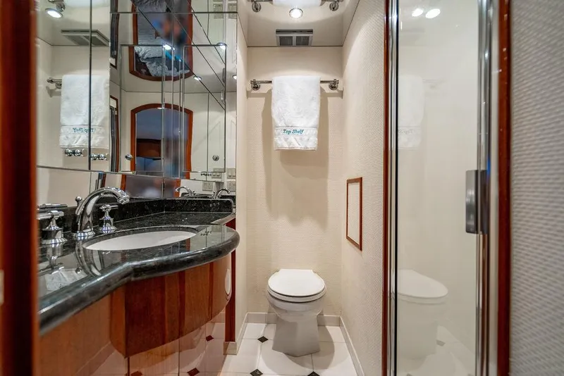 Slide: The Image of Luxurious bathroom in 2007 Hatteras Enclosed Flybridge yacht with elegant fixtures and mirrored walls. - 23