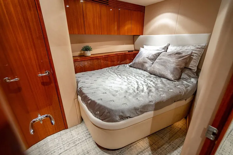 Slide: The Image of Luxurious bedroom in 2007 Hatteras Enclosed Flybridge yacht with elegant wood cabinetry. - 24