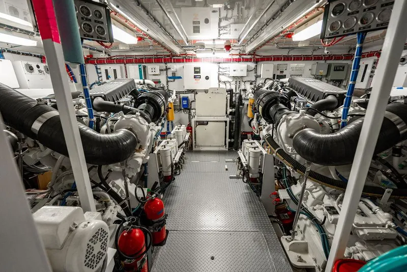 Slide: The Image of Engine room of 2007 Hatteras Enclosed Flybridge yacht, showcasing dual engines and equipment. - 31