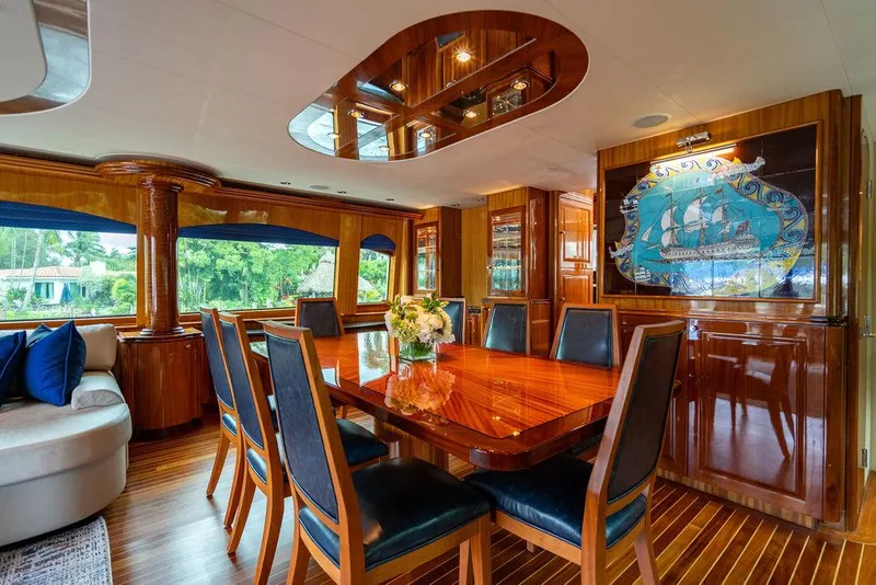 Slide: The Image of Luxurious dining area on 2007 Hatteras Enclosed Flybridge yacht with elegant wood finishes. - 8