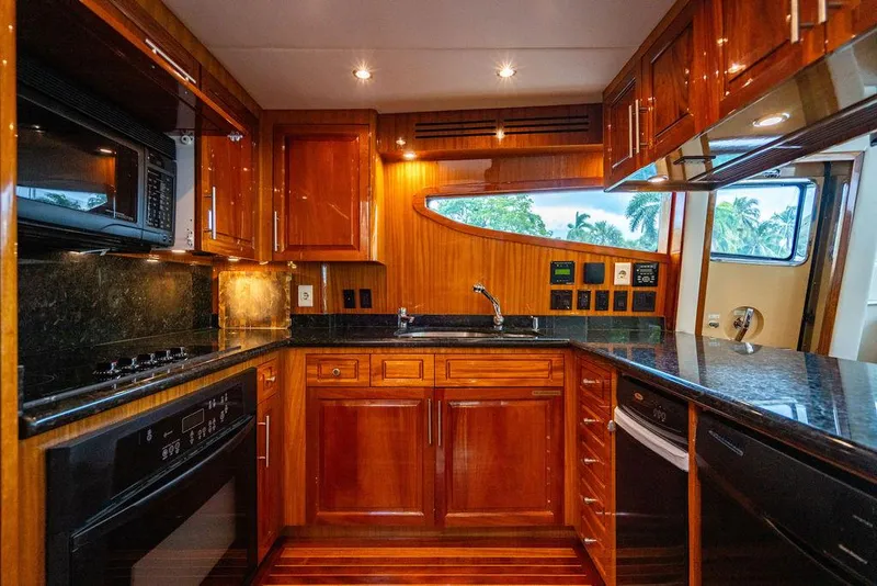 Slide: The Image of Luxurious 2007 Hatteras Enclosed Flybridge yacht kitchen with wood cabinetry and modern appliances. - 9