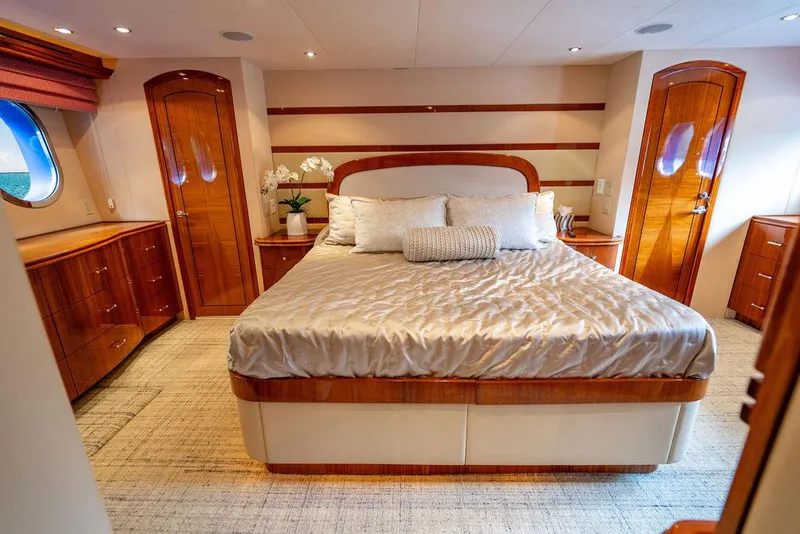 Slide: The Image of Luxurious bedroom interior of 2007 Hatteras Enclosed Flybridge yacht with elegant wood finishes. - 18