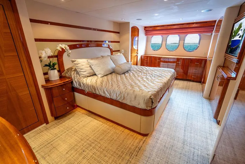 Slide: The Image of Luxurious bedroom interior of 2007 Hatteras Enclosed Flybridge yacht with elegant wood finishes. - 19