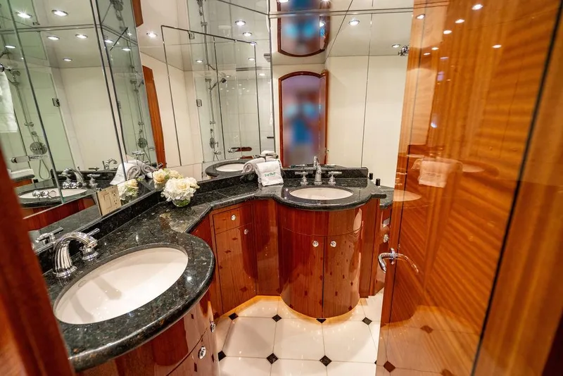 Slide: The Image of Luxurious bathroom on 2007 Hatteras Enclosed Flybridge yacht with dual sinks and elegant wood cabinetry. - 20