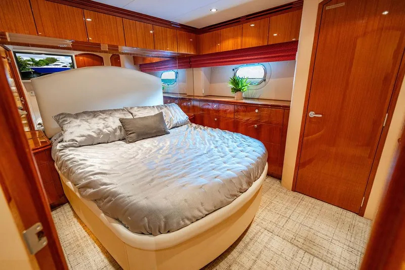 Slide: The Image of Luxurious bedroom interior of 2007 Hatteras Enclosed Flybridge yacht with elegant wood finishes. - 21