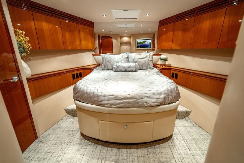 Slide: The Image of Luxurious bedroom interior of 2007 Hatteras Enclosed Flybridge yacht with elegant wood finishes. - 27