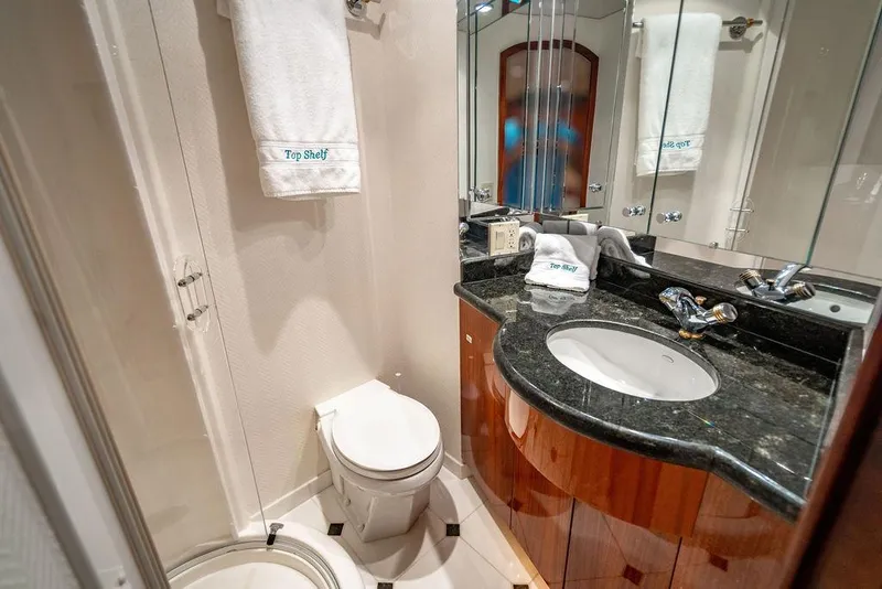 Slide: The Image of Luxurious bathroom in 2007 Hatteras Enclosed Flybridge yacht with elegant fixtures and marble countertop. - 29