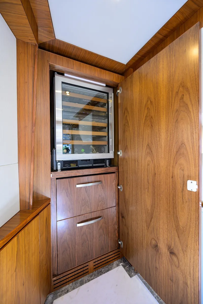 Slide: The Image of Wood-paneled interior of 2018 Hargrave 100 Raised Pilothouse yacht with built-in wine cooler. - 40