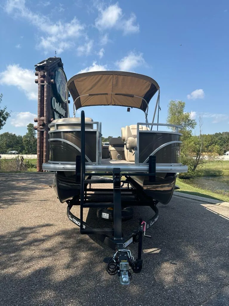 Slide: The Image of 2025 Sun Tracker SportFish 20 DLX pontoon boat on trailer, parked outdoors. - 3
