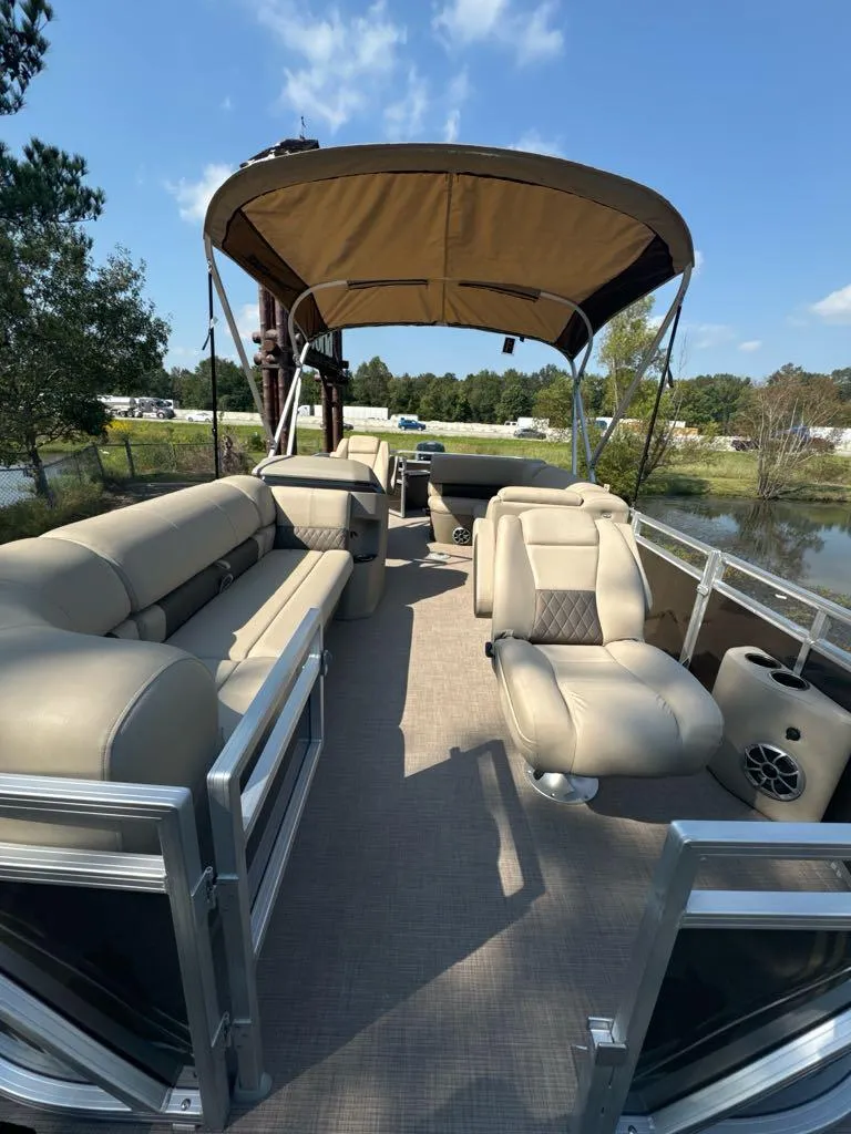 Slide: The Image of 2025 Sun Tracker SportFish 20 DLX pontoon boat with spacious seating and canopy. - 4