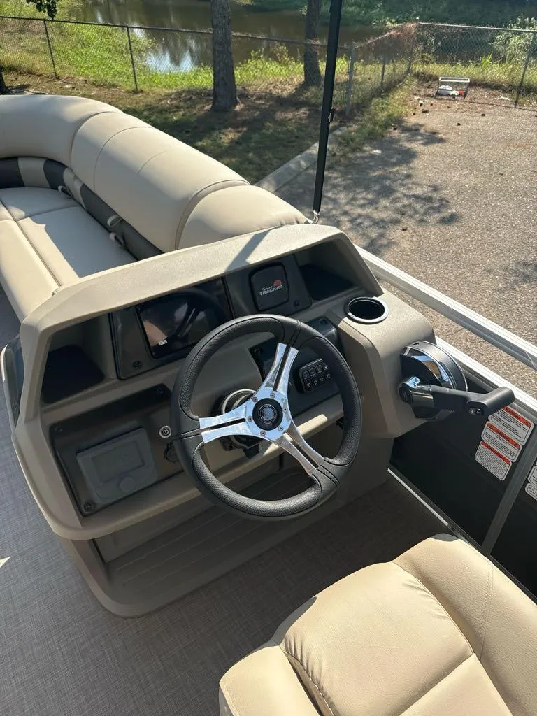 Slide: The Image of 2025 Sun Tracker SportFish 20 DLX boat interior with steering wheel and seating. - 7