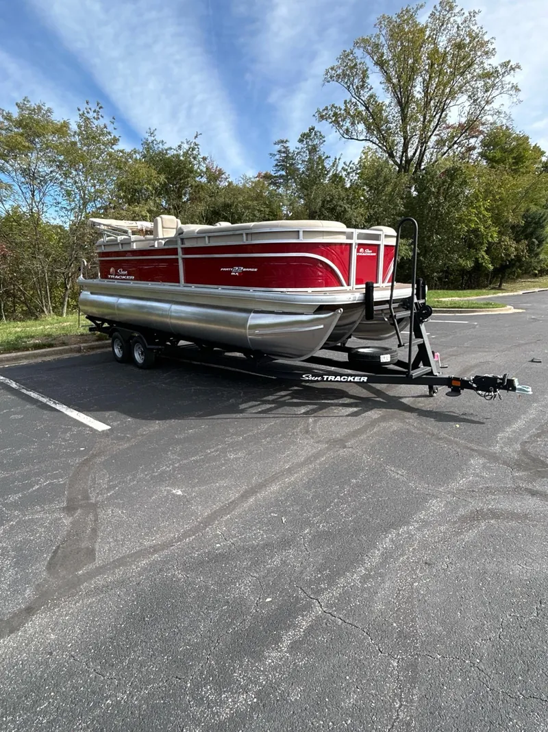 Slide: The Image of 2025 Sun Tracker Party Barge 22 XP3 pontoon boat on trailer in parking lot. - 3
