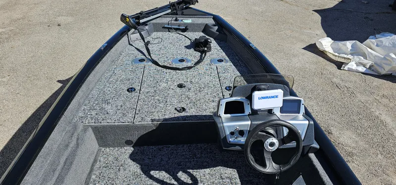 Slide: The Image of 2025 Tracker Pro Team 175 Crappie Edition boat interior with steering console and fishing deck. - 4