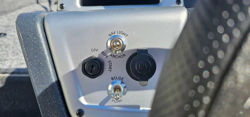 Slide: The Image of Control panel of 2025 Tracker Pro Team 175 Crappie Edition boat with switches and ports. - 7