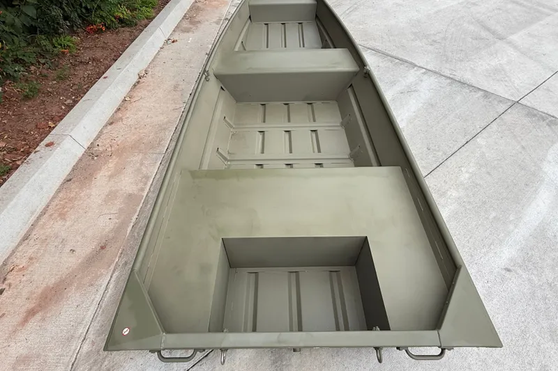 The Image of 2025 Tracker Grizzly 1436 Utility boat on concrete surface, showcasing interior layout. - 0