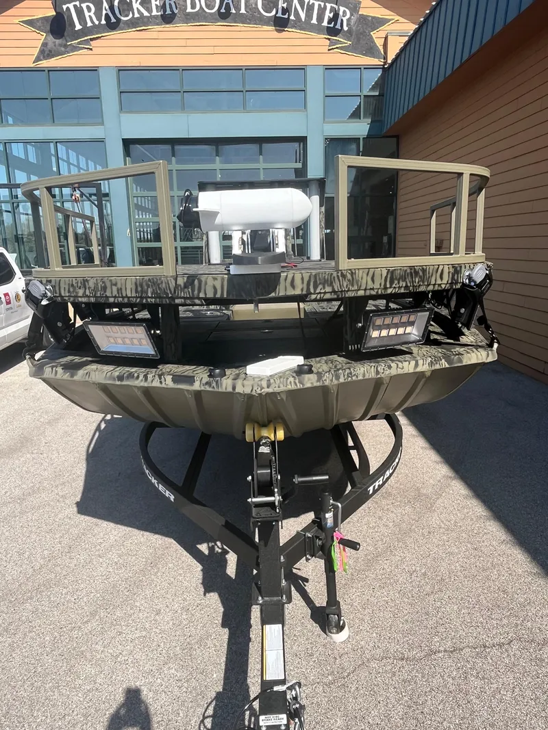 Slide: The Image of 2025 Tracker Grizzly 2072 CC Sportsman boat at dealership entrance. - 49