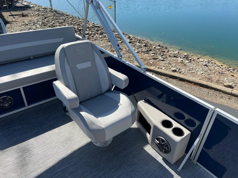 Slide: The Image of Captain's chair on 2025 Godfrey Xperience 2286 SFL pontoon boat, near water. - 13