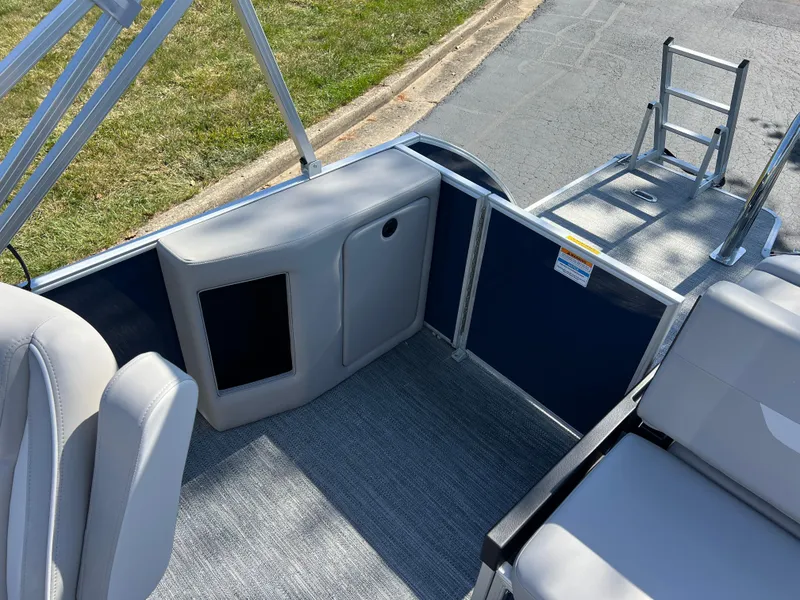 Slide: The Image of 2025 Godfrey Xperience 2286 SFL boat interior with seating and ladder, showcasing modern design. - 14